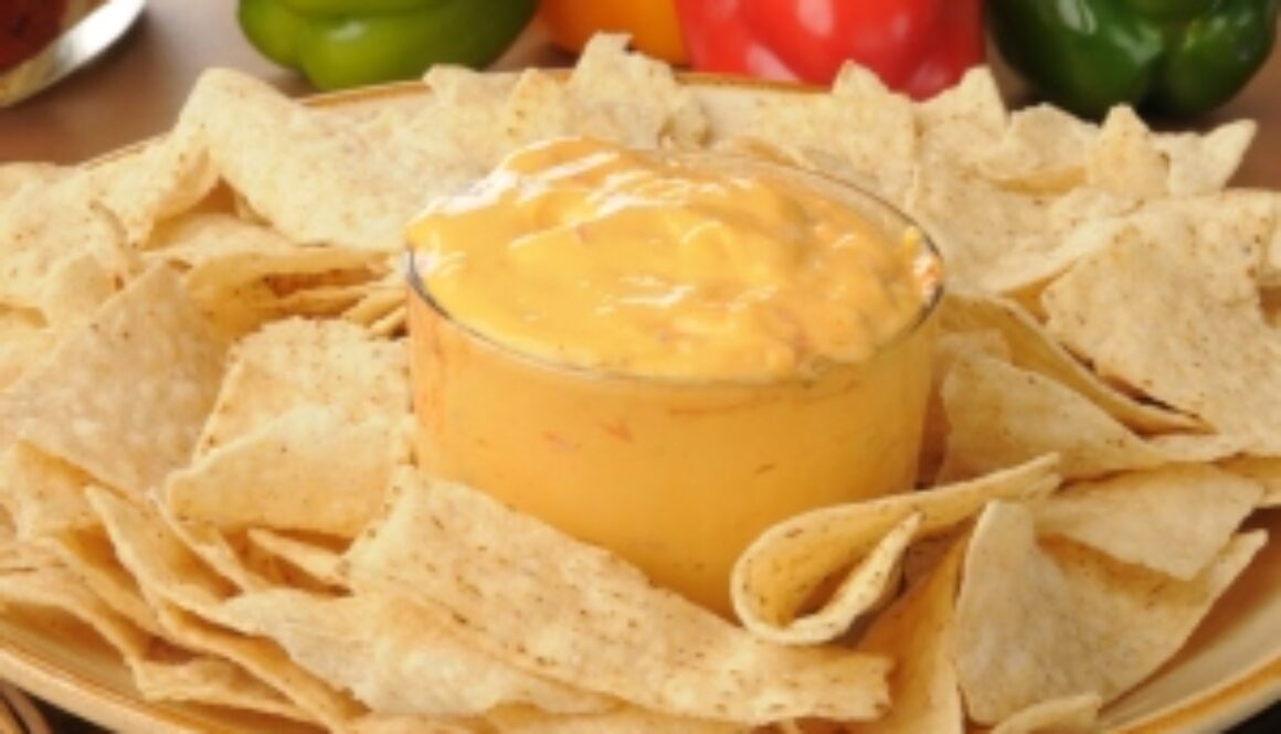 A platter of tortilla chips with salsa con queso
