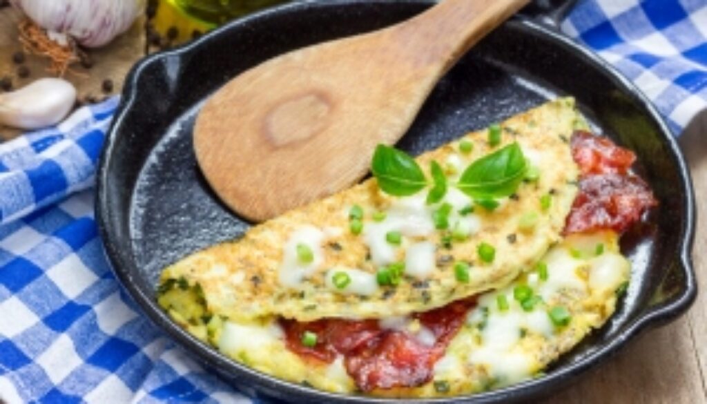 Bacon stuffed omelette on a iron cast pan